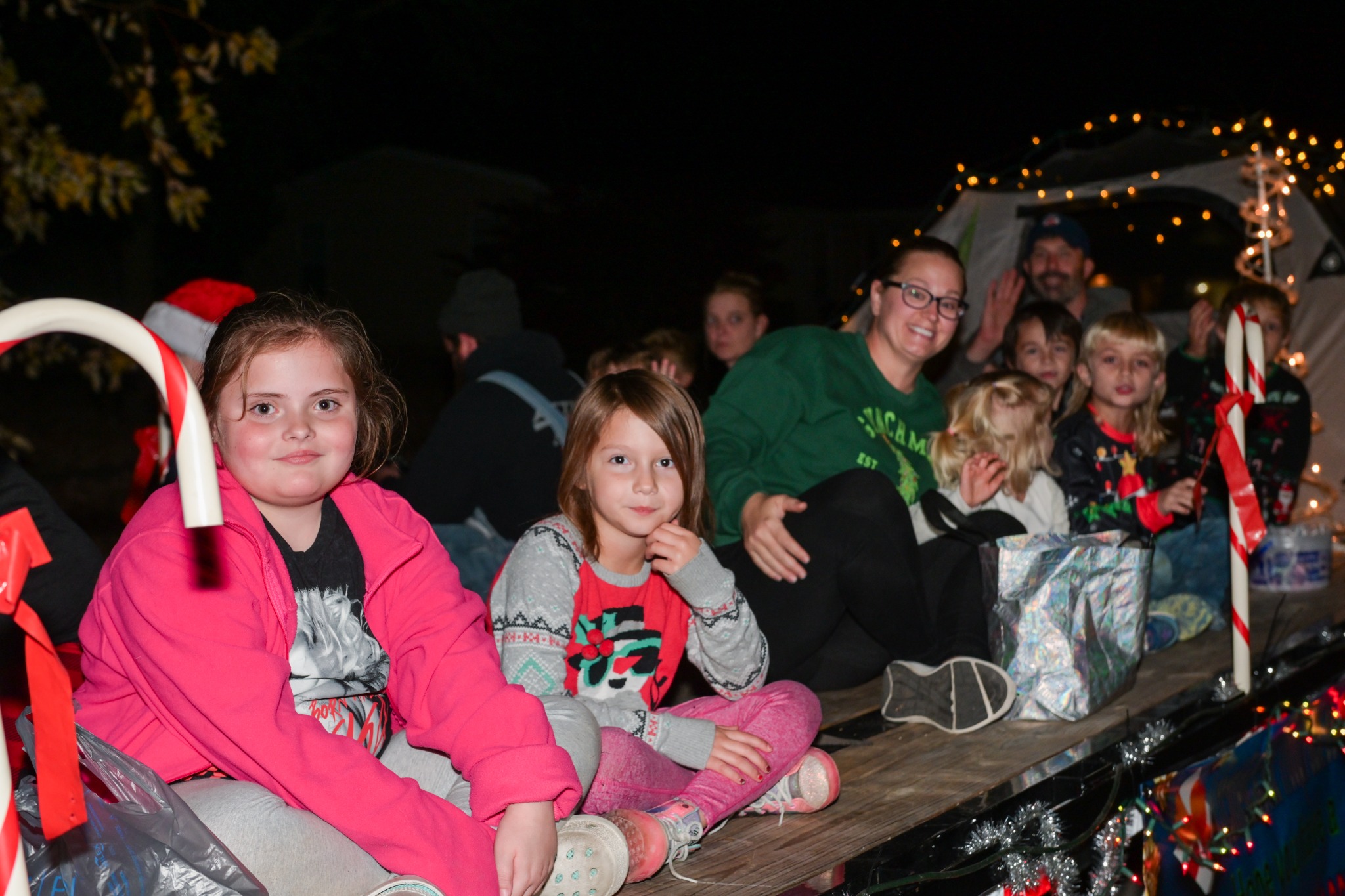 Families and children riding on a Christmas parade float