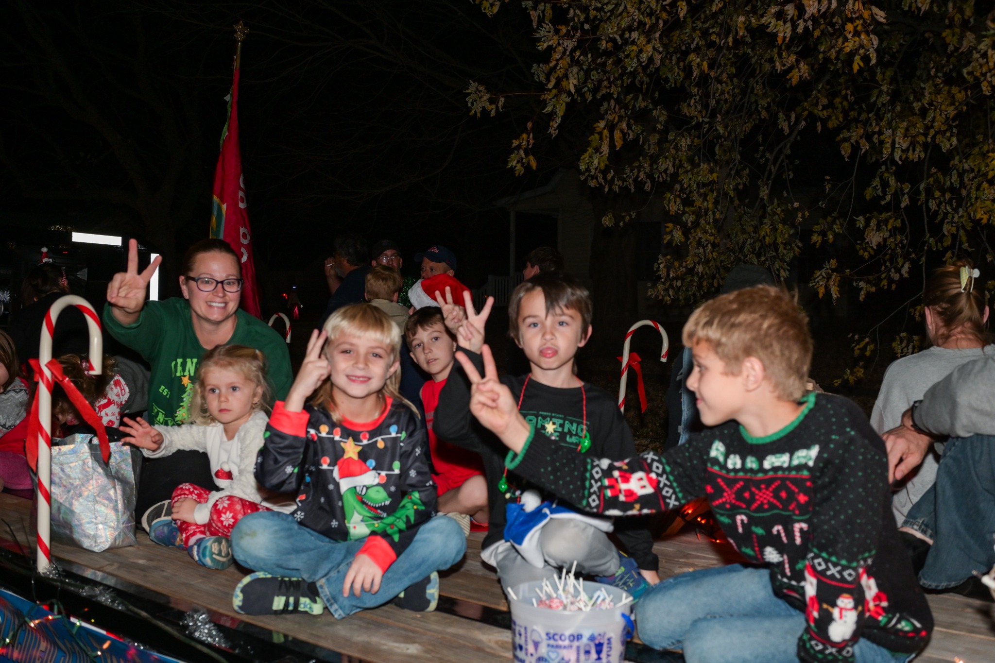 Children and families waving from a Christmas parade float