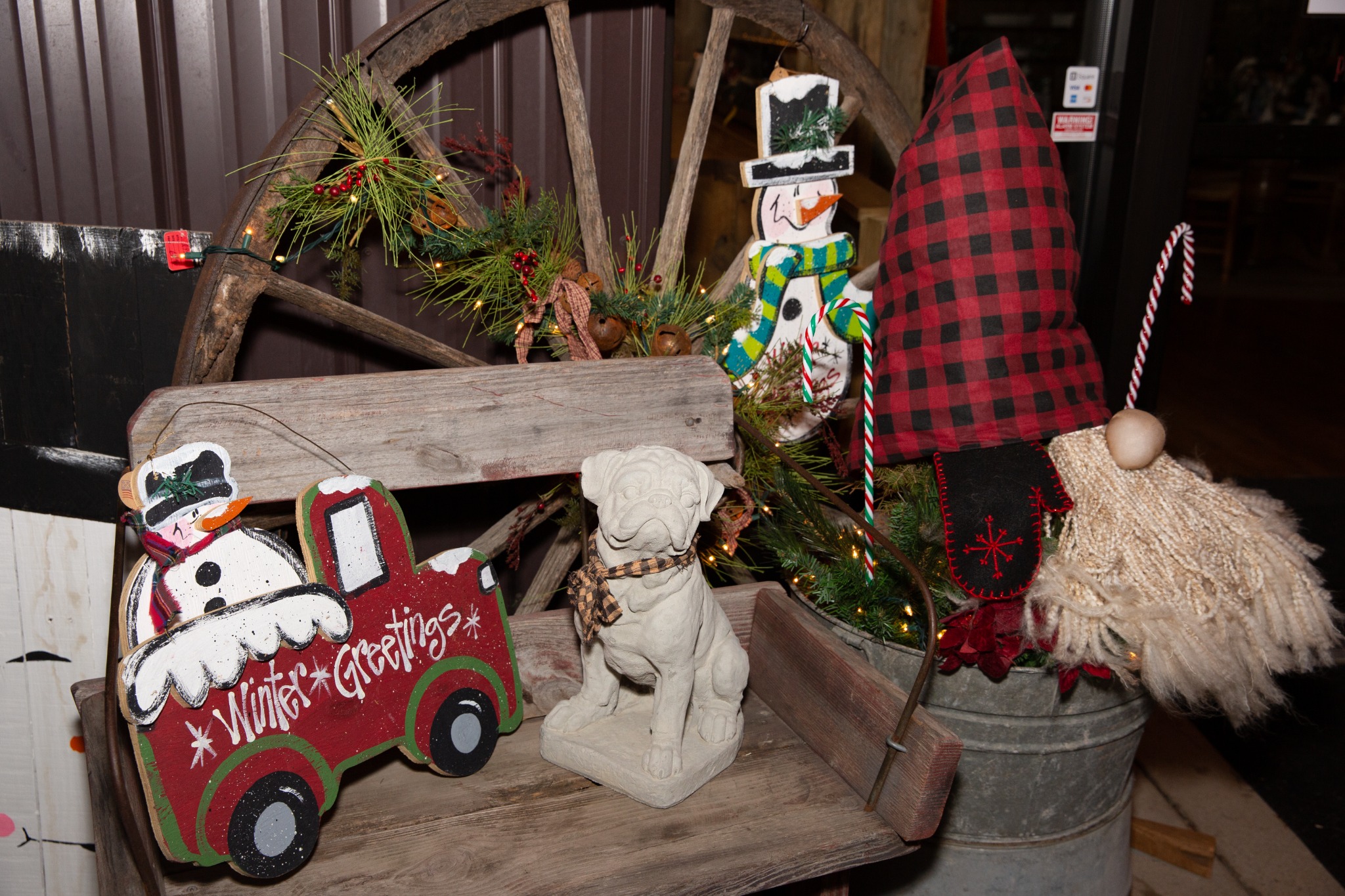 Rustic winter decor display with wagon wheel and gnome