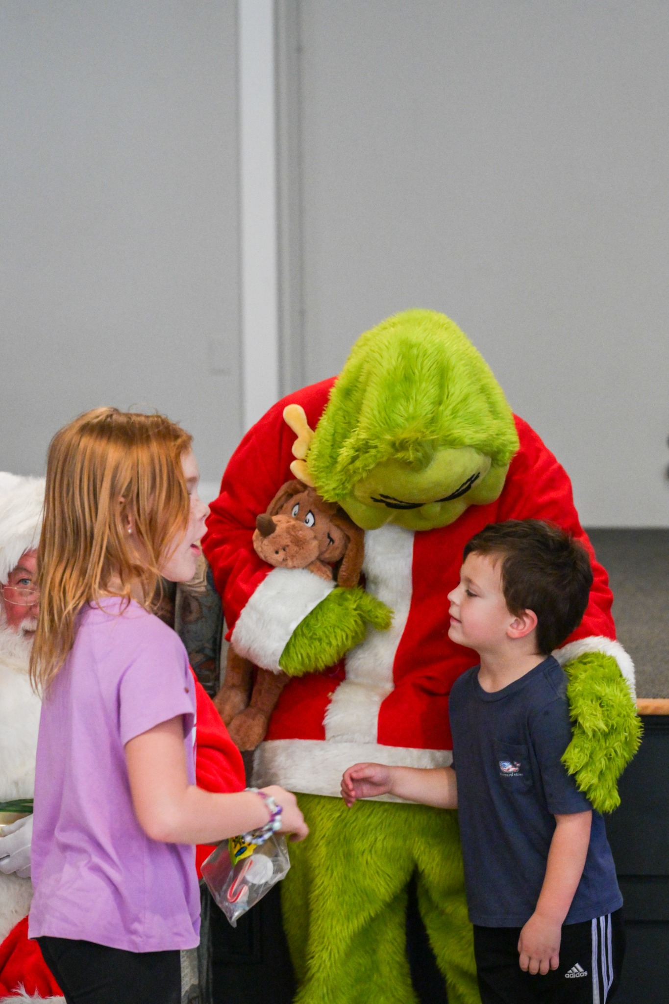The Grinch visiting with children at Festival of Trees