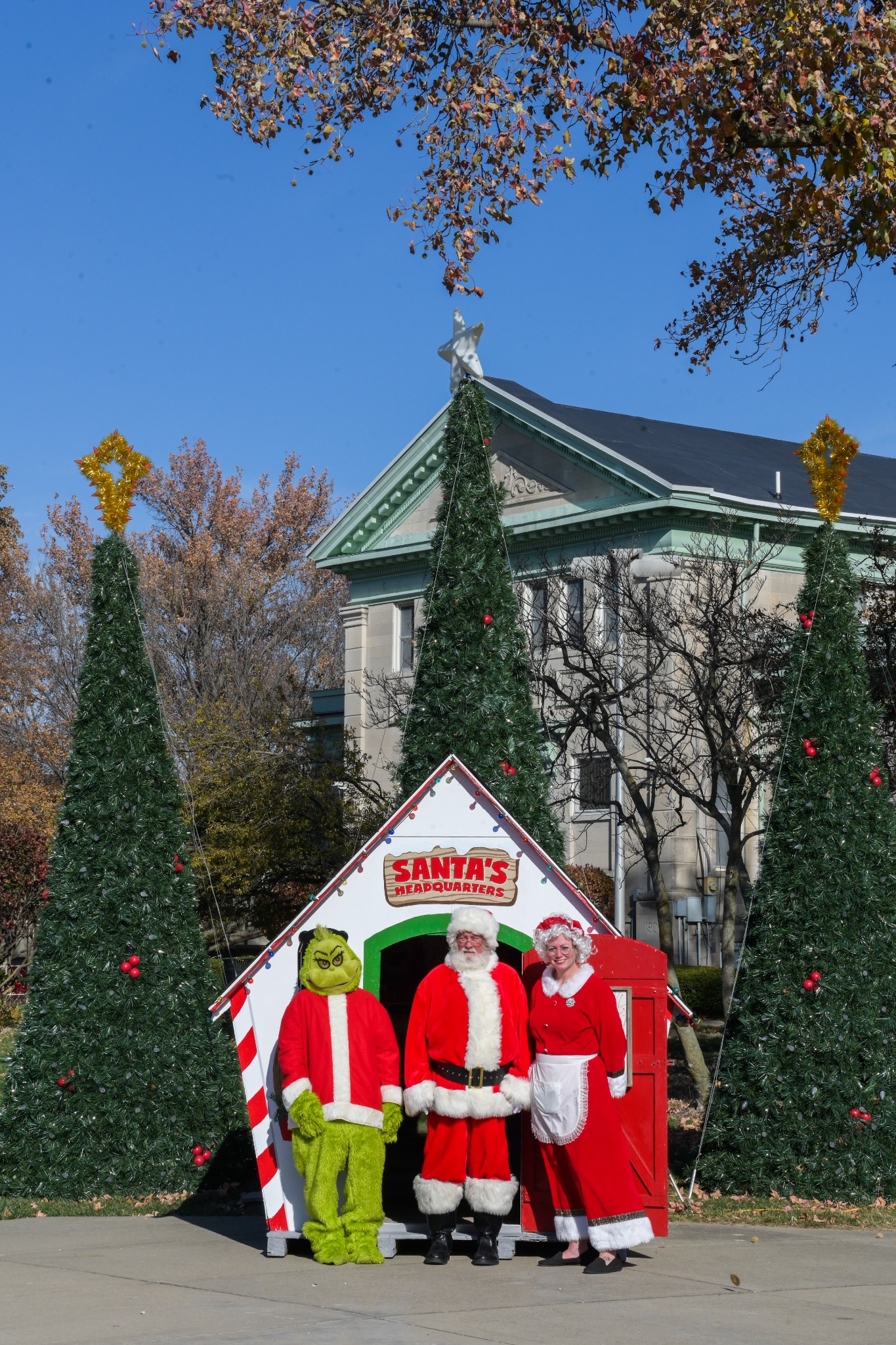 Tall photo of Santa, Mrs. Claus and the Grinch at Santa's Headquarters